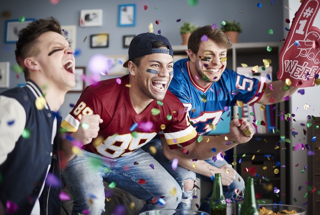 Football fans celebrating in Nashville wearing jerseys, laundry tips in Nashville.