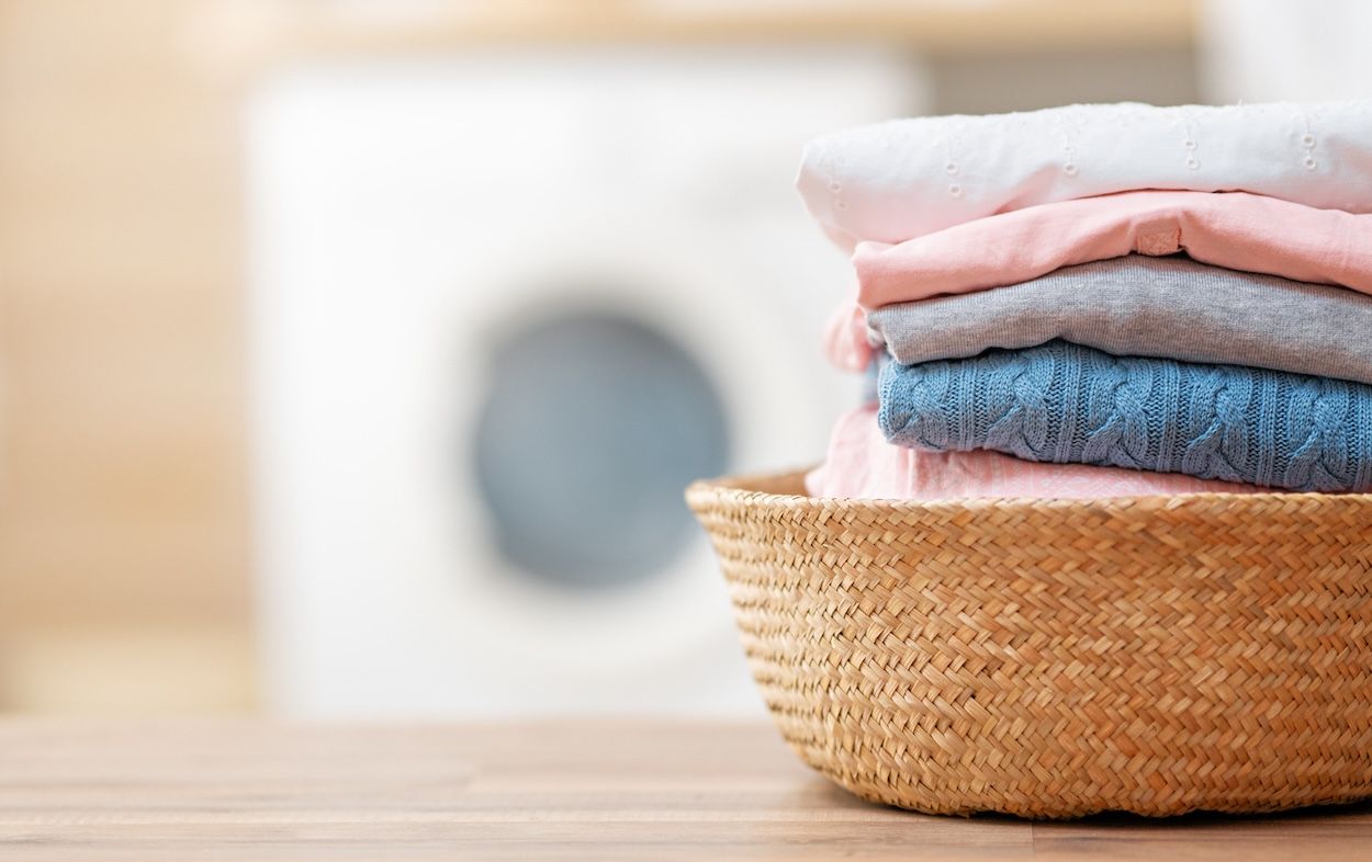 Clothes in the basket in the laundry room.